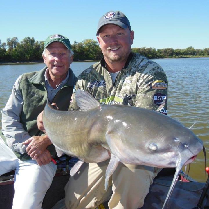 2 men with holding a big catfish