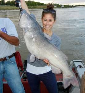 Woman with 34.5 inch 26Lbs Femail Chanel Catfish on a boat