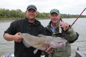 2 men fishing on a boat