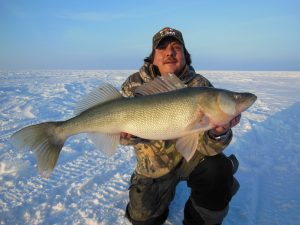 Anger with ice fishing catch